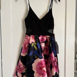 Adorable mini floral dress with mesh cut outs.
